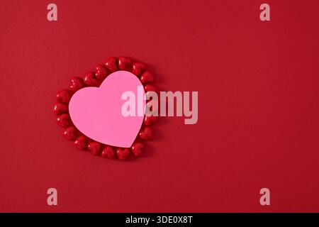Heart shape sticky notes laying on rose petals Stock Photo