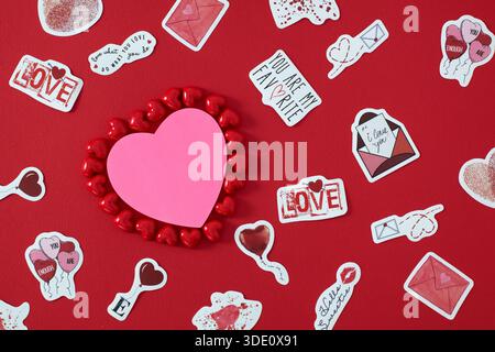 Heart shape sticky notes laying on rose petals Stock Photo