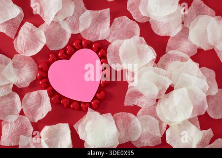 Heart shape sticky notes laying on rose petals Stock Photo