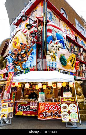 Nebuta-style signboards on the facade of Kushikatsu Yokozuna Tsutenkaku restaurant in famous retro Shinsekai district, Ebisuhigashi, Osaka, Japan Stock Photo
