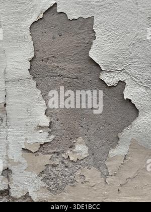 Peeling paint texture on weathered concrete wall showing signs of age and decay, perfect background. Mobile photo Stock Photo