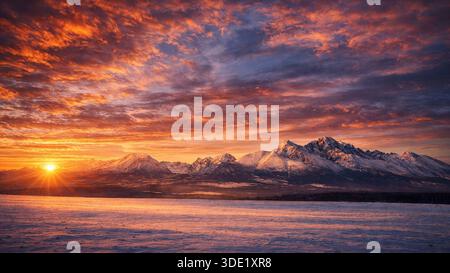 Dramatic Winter Sunrise Over Snowy High Tatras Mountains, Slovakia Stock Photo