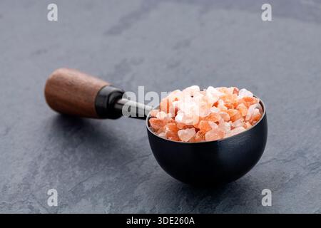 Fine Himalayan pink salt - Pure crystal salt in a measuring spoon. Stock Photo