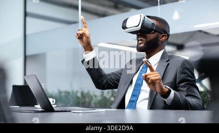 Man Uses Virtual Reality Headset in Office Setting During Work Hours Stock Photo