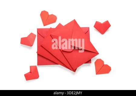 Composition with red envelopes and origami hearts isolated on white background. Valentine's Day celebration Stock Photo