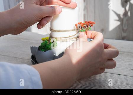 Unrecognizable woman creating Easter holiday decoration from sustainable materials egg shell. Diy do it yourself step by step instruction. Gift present idea Crafting preparation holiday Stock Photo
