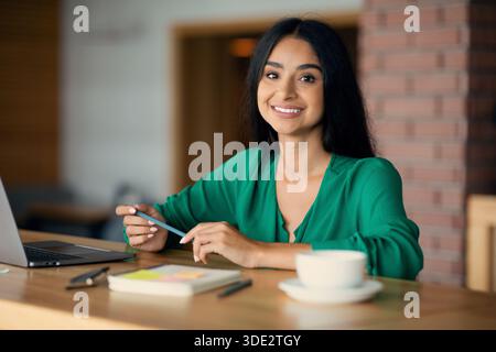 Beautiful indian woman freelancer working from cafe Stock Photo