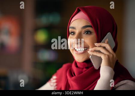 Portrait of pretty muslim lady talking on cellphone Stock Photo