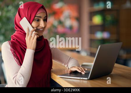 Muslim young woman independent contractor working at cafe Stock Photo