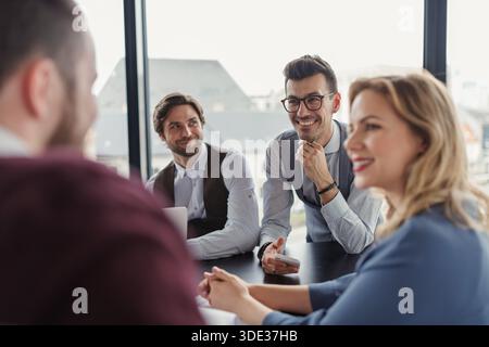 Business colleagues sharing ideas, discussing new project. Stock Photo