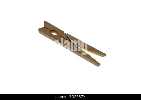 Wooden clothespin rests on a white surface. It can be used for hanging laundry, organizing papers, or crafting projects. Practical tool with simple de Stock Photo
