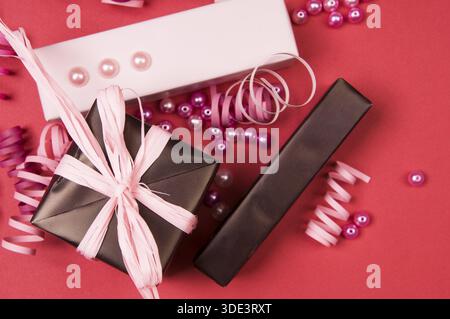 Set of gift boxes with bows, beads and ribbons on a colored background Stock Photo