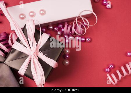 Set of gift boxes with bows, beads and ribbons on a colored background Stock Photo