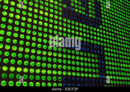 a wall made of beer bottles illuminated from behind Stock Photo