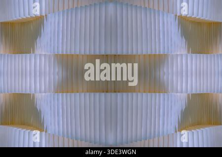 abstract, modern architectural structure composed of numerous vertical, pleated white panels. The lighting is soft, casting subtle shadows that accent Stock Photo