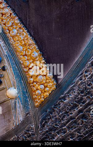 an abstract close-up of textured materials. The image features a diagonal split between a golden-yellow, bubble-like textured surface on the left and Stock Photo