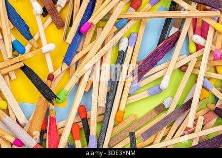 matchsticks of various shapes and colors with multicolored paper sticky notes on background Stock Photo