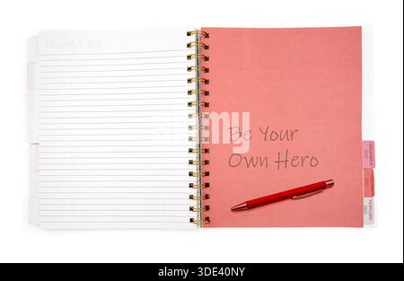 notebook with the inscription BE YOUR OWN HERO on white background Stock Photo