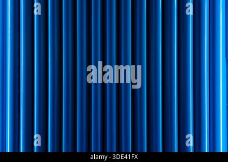 vibrant blue velvet curtains with vertical pleats, creating a rich, textured background. The curtains are evenly spaced, with a slight sheen that high Stock Photo