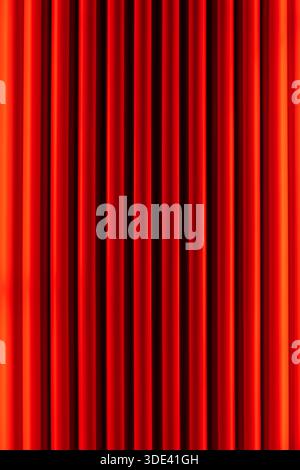 vibrant red velvet curtains with vertical pleats, creating a rich, textured background. The curtains are evenly spaced, with a slight sheen that highl Stock Photo