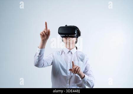 Woman finalizing virtual reality interface design decision using hand gestures in immersive VR UI UX design workspace Stock Photo