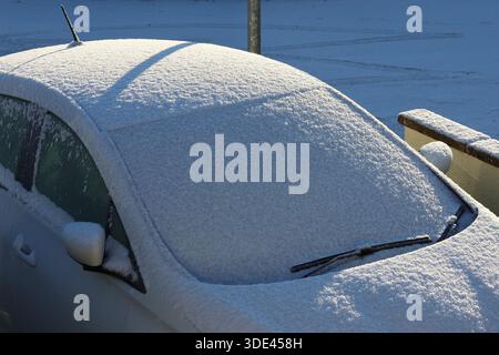 Close up of a car windscreen covered in snow and ice  first thing in the morning after a night of snowfall Stock Photo
