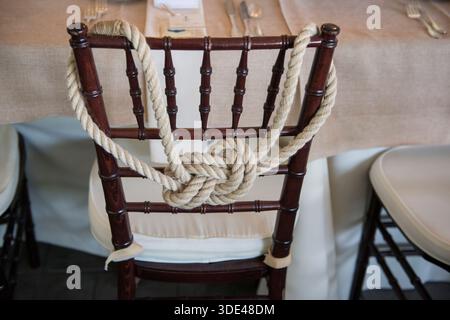 Nautical Rope Knot Decor on Wedding Reception Chair Stock Photo