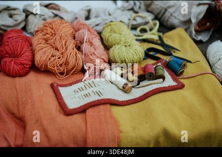 Needles with colored threads and yarns Stock Photo