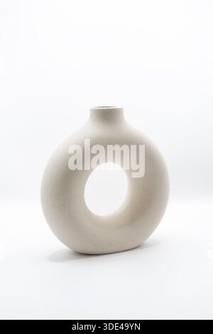 A modern ceramic flower vase, shaped to have an open cemtre Stock Photo