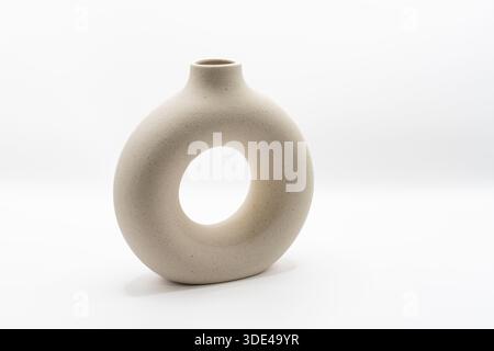 A modern ceramic flower vase, shaped to have an open cemtre Stock Photo