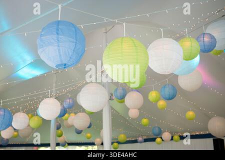 Colorful Paper Lanterns Hanging in Event Tent Stock Photo