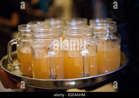 Warm Apple Cider in Mason Jars on Serving Tray Stock Photo