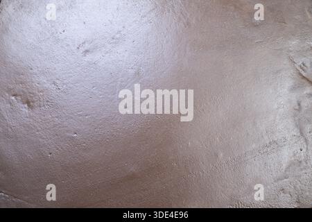 moist sand surface with sparkling sheen, closeup coastal ground texture showing fine granular detail, subtle tidal ripple marks and soft reflective hi Stock Photo