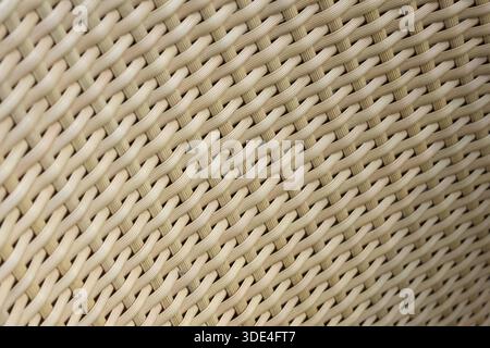 Detailed texture background of beige woven wicker material showing intricate crisscross pattern and sturdy craft with warm and natural feeling suitabl Stock Photo