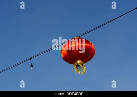 Red Chinese Paper Lantern Hanging Against Clear Blue Sky – Minimalist Decoration Background Stock Photo