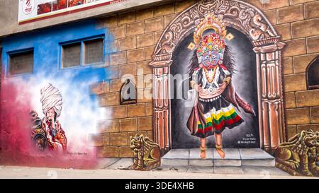 A colorful wall painting featuring traditional motifs and masks that vividly represent Nepalese culture and artistic heritage. Stock Photo
