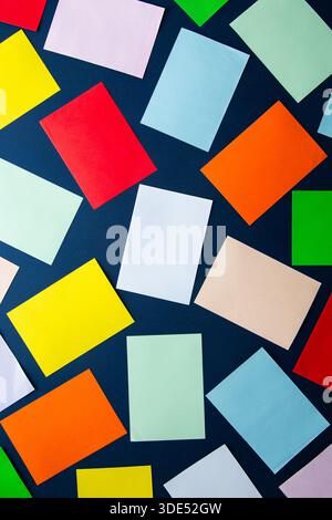 Scattered colorful rectangular paper sheets creating an abstract background Stock Photo