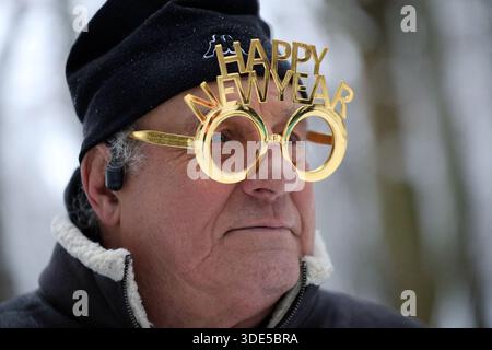 Older Man Wearing Novelty New Year Glasses Outdoors Stock Photo
