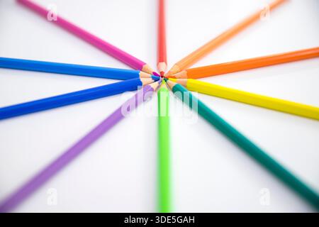 Colorful wooden pencils arranged in creative patterns on a neutral background, perfect for design, education, and creative concepts. Stock Photo