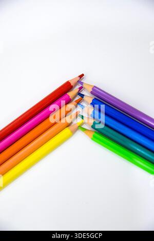 Colorful wooden pencils arranged in creative patterns on a neutral background, perfect for design, education, and creative concepts. Stock Photo