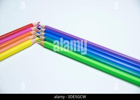 Colorful wooden pencils arranged in creative patterns on a neutral background, perfect for design, education, and creative concepts. Stock Photo
