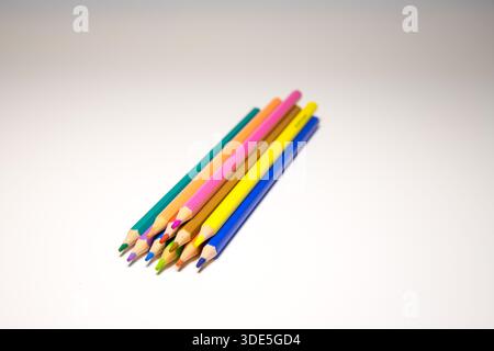 Colorful wooden pencils arranged in creative patterns on a neutral background, perfect for design, education, and creative concepts. Stock Photo
