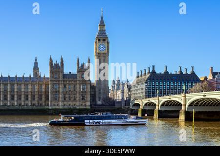 Uber Boat river bus by Thames Clippers on River Thames, Westminster Bridge, Elizabeth Tower / Big Ben and Palace of Westminster in London, England, UK Stock Photo