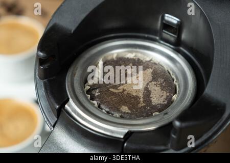 Used coffee pad in the coffee machine after making coffee. Stock Photo