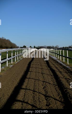 Epsom downs racecourse on a sunny winters day with snow on ground Stock Photo