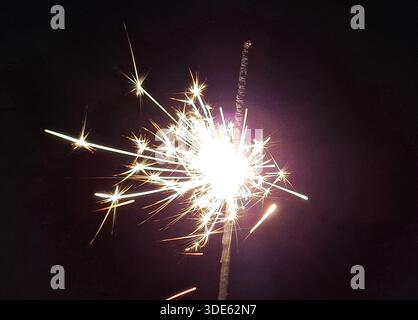 Burning sparkler on a black background Stock Photo