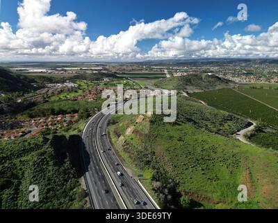 Aerial view of lush green agricultural fields with active irrigation ...
