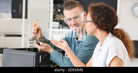 Electronic technicians working in service center Stock Photo