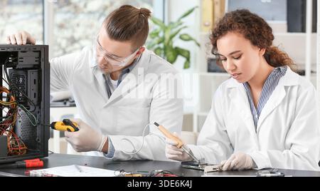 Electronic technicians working in service center Stock Photo