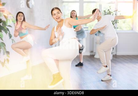 Teenagers practicing breakdance toprock moves in training hall. Teenagers engaged in breakdance Stock Photo